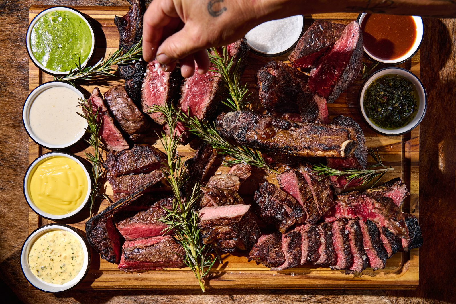 Wood-fired Tumalo steak board with signature sauces and grilled onions