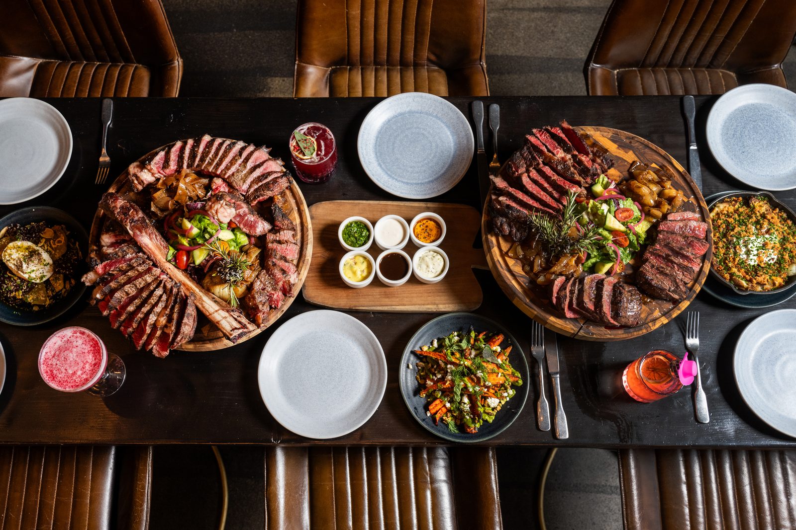 Tumalo steak boards with Hawkeye's signature sauces, sides, and grilled onions